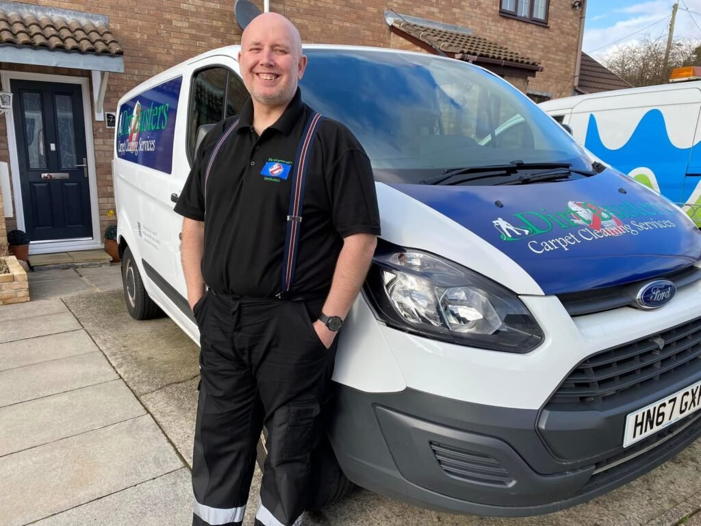 Russell Trowbridge of Dirt Busters Carpet Cleaning standing beside his branded van in Bridgend