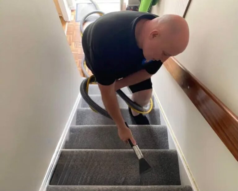 Russell cleaning a stair carpet