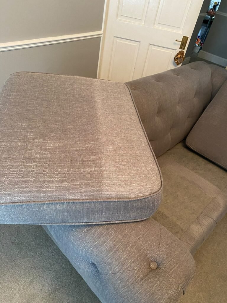 Grey sofa arm showing cleaned fabric